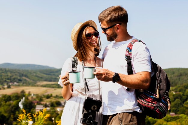 Man and woman looking at each other and drinking coffee