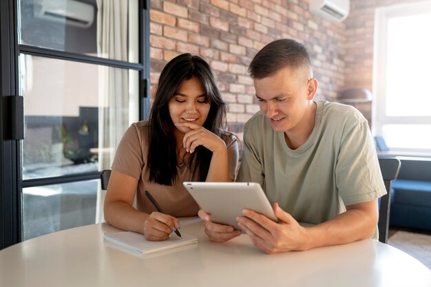 Man and woman making shopping list with tablet