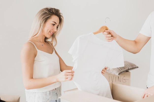 Man and woman packing t-shirt in box