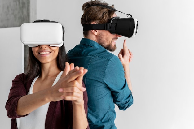 Man and woman play with virtual reality headset at home together