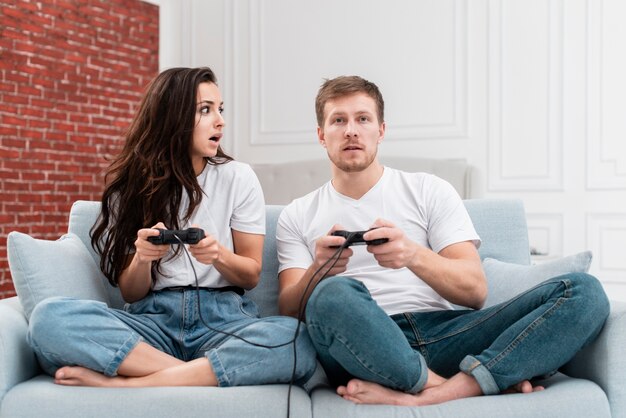 Man and woman playing a game with controllers