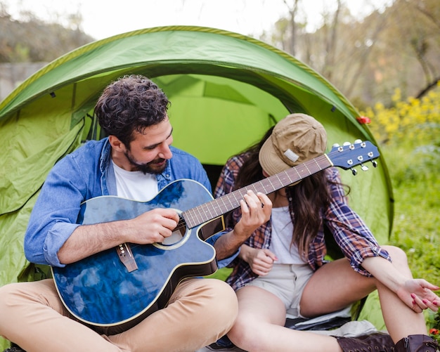 Free photo man and woman playing guitar