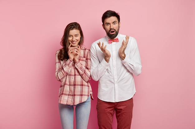 Man and woman posing in colorful clothes