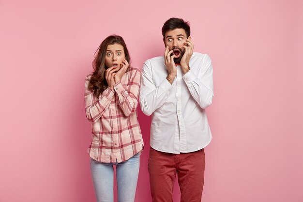 Man and woman posing in colorful clothes