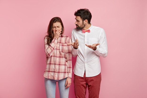 Man and woman posing in colorful clothes