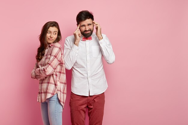 Man and woman posing in colorful clothes