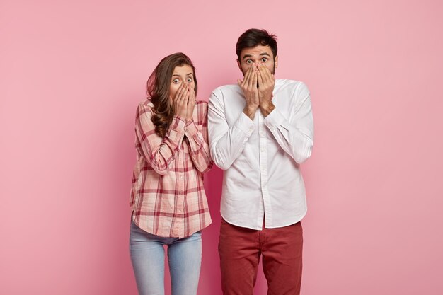 Man and woman posing in colorful clothes