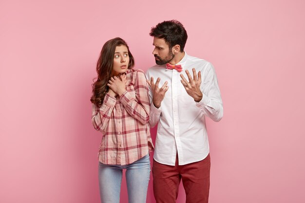 Man and woman posing in colorful clothes