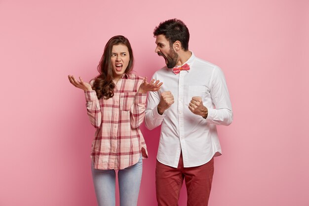 Man and woman posing in colorful clothes