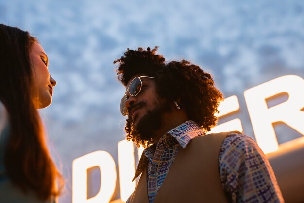 Man and woman posing in retro style outside diner