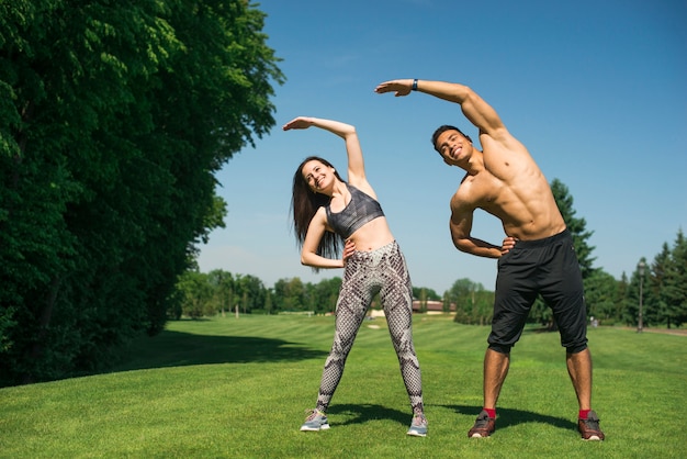 Man and woman practicing yoga outdoor