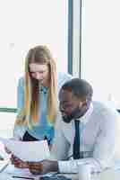 Free photo man and woman reading a business paper