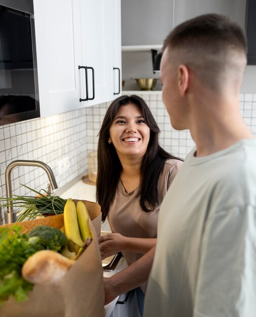 Man and woman receiving paper grocery bags after online shopping