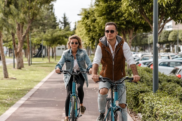 Free photo man and woman riding their bikes