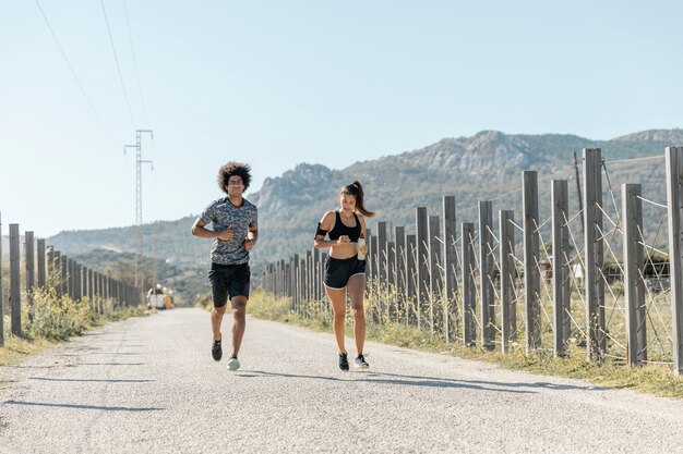 Man and woman running along road