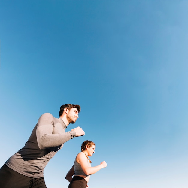 Man and woman running on street