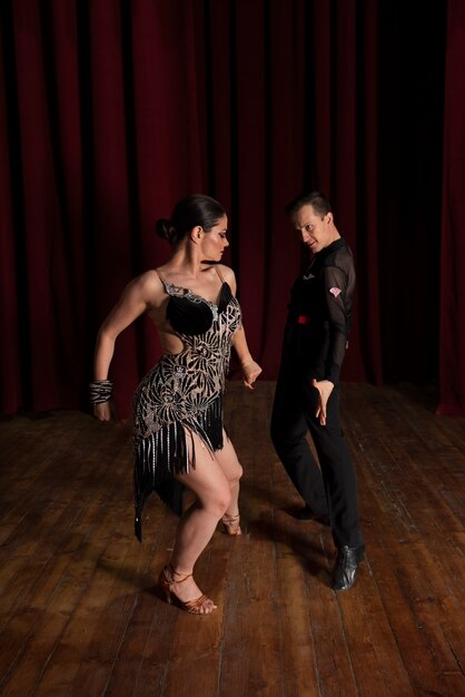 Man and woman showing ballroom dancing together