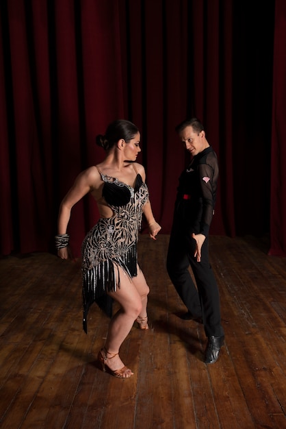 Man and woman showing ballroom dancing together