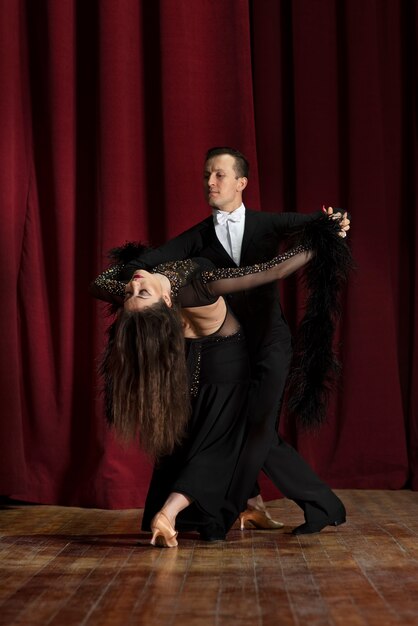 Man and woman showing ballroom dancing together