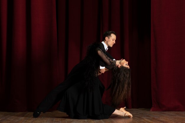 Man and woman showing ballroom dancing together