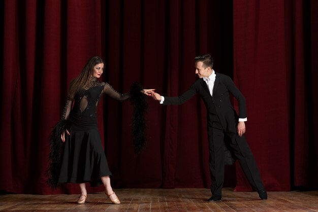 Man and woman showing ballroom dancing together