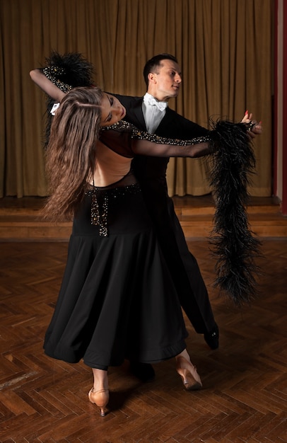 Man and woman showing ballroom dancing together