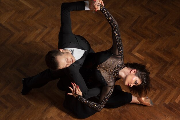 Man and woman showing ballroom dancing together