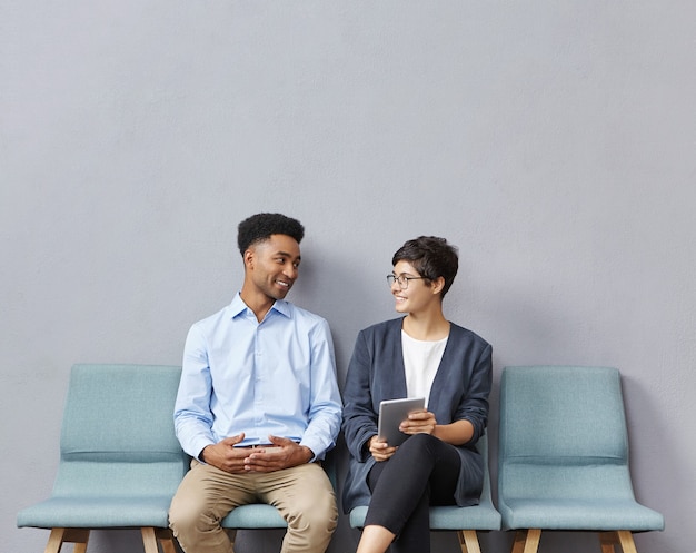 Free photo man and woman sitting in waiting room