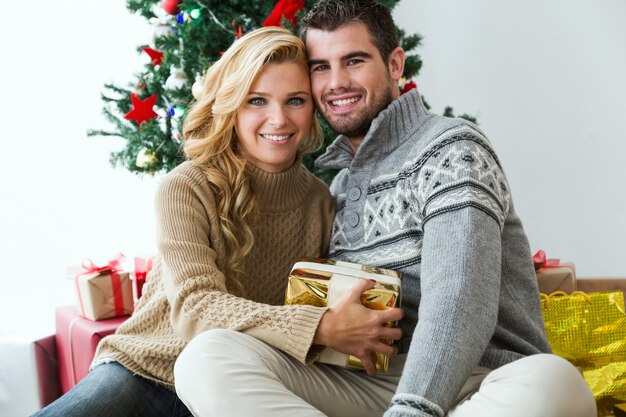 Man and woman smiling with a gift