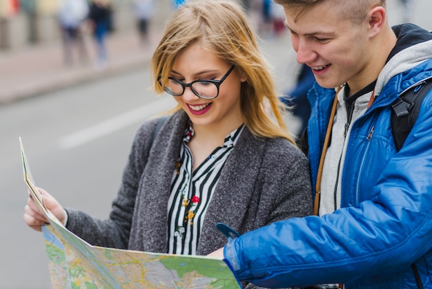 Man and woman smiling with map