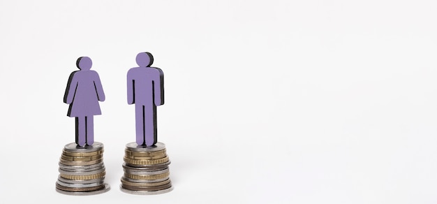 Man and woman standing on piles of coins