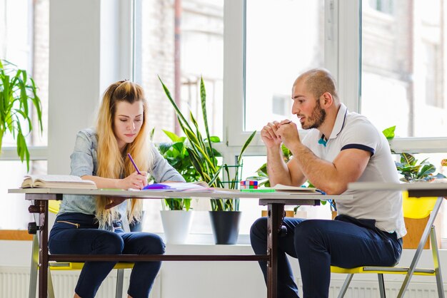 Man and woman at table studying