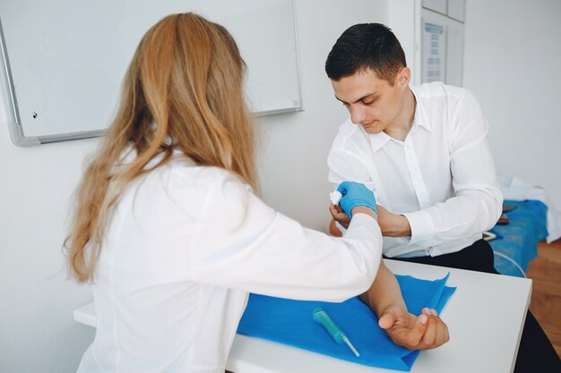 Man and woman take blood for analysis