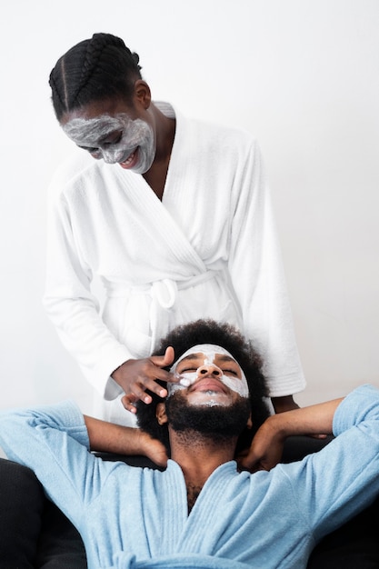 Man and woman taking care of their face at home