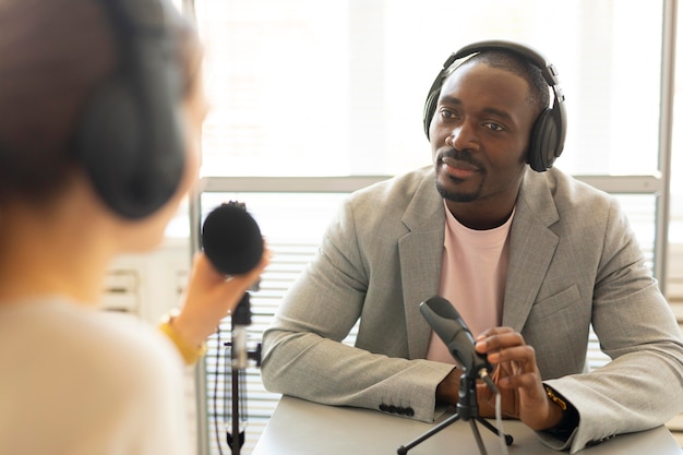 Man and woman talking in a podcast