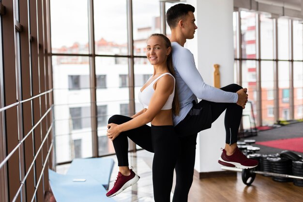 Man and woman teamwork at fitness class