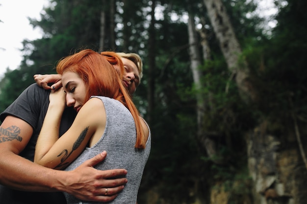 Man and woman tenderly hugging in nature