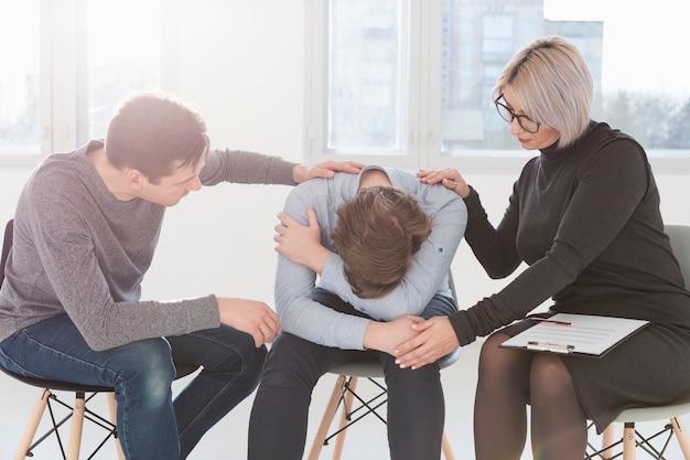 Foto gratuita uomo e donna che provano a consolare il paziente