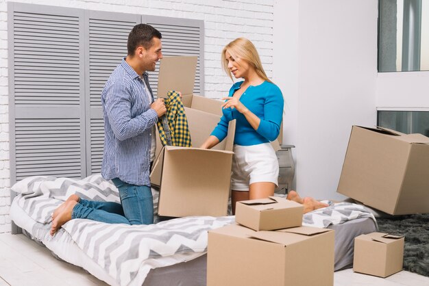 Man and woman unpacking boxes