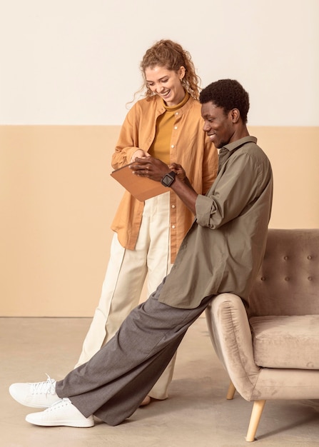 Man and woman using a digital tablet long view