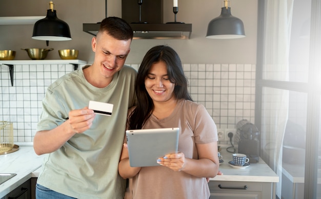 Мужчина и женщина с помощью планшета для покупок в Интернете с помощью кредитной карты