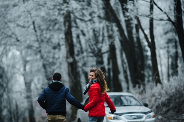 Man and woman walking together on winter park