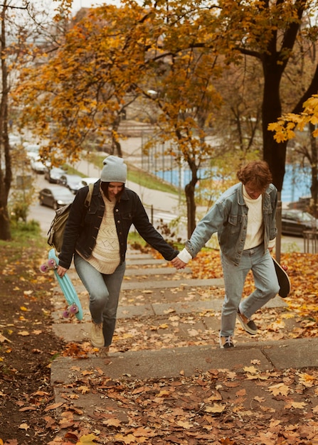 Free photo man and woman walking while holding hands