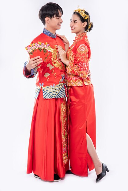 The man and woman wear Cheongsam glad to receive gift money and cash