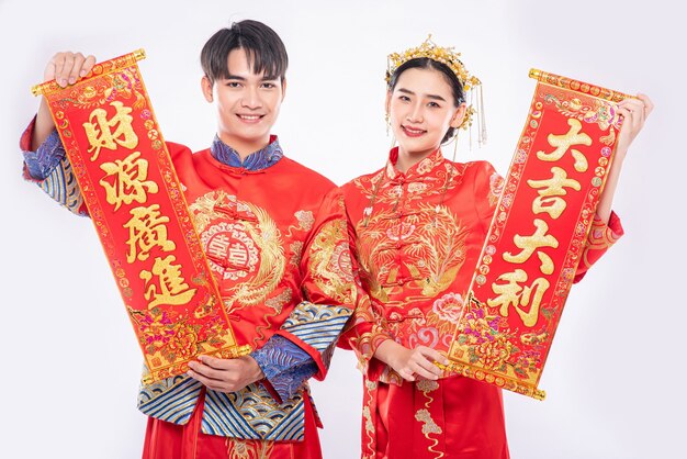 Man and woman wear Cheongsam suit celebrate chinese new year with chinese greeting card