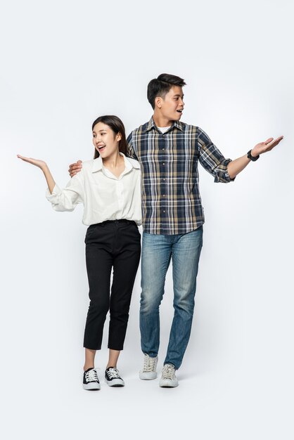 man and woman wearing shirts and happily extended their hands to the side