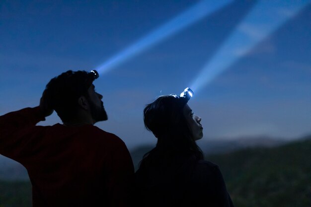 Man and woman with head lights