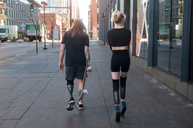 Man and woman with leg disability exercising in the city
