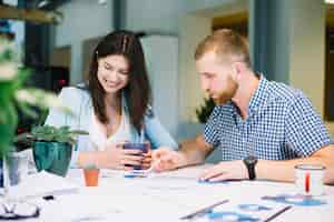 Free photo man and woman working on diagrams together