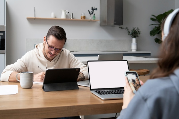 Man and woman working together from home at desk